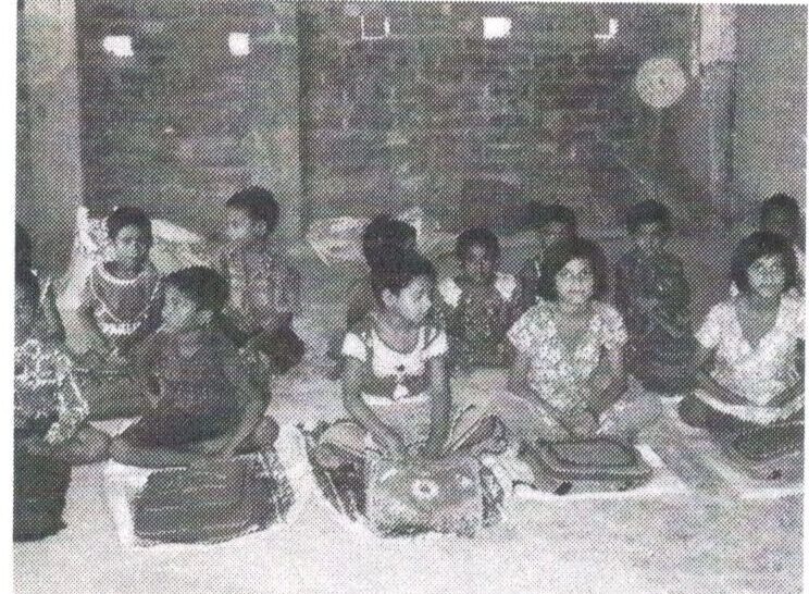 Children seated on the floor in a classroom